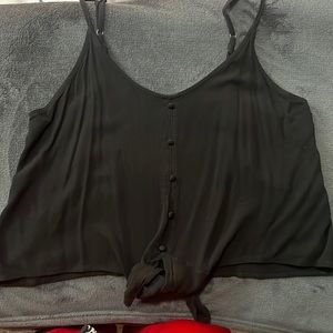 Black flowing tank top with buttons and tie at bottom